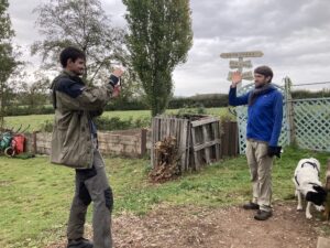 Sam recording a garlic-planting tutorial at Flower Pod