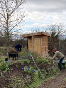 Photo of volunteers working on building Flower Pod's composting loo